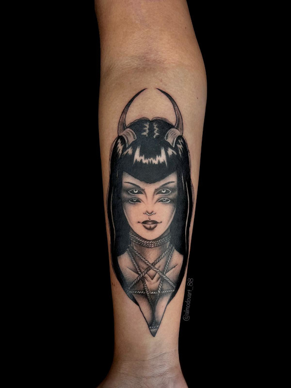 Detailed forearm tattoo in black and grey of teen titan demon witch raven with pentagram necklace by tattoo artist Lita Almodovar of Sacred Mandala Studio in Durham, NC.